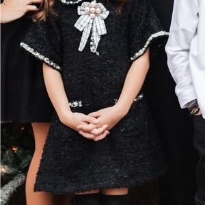 Elegant Black Tweed Dress with Pearl Brooch